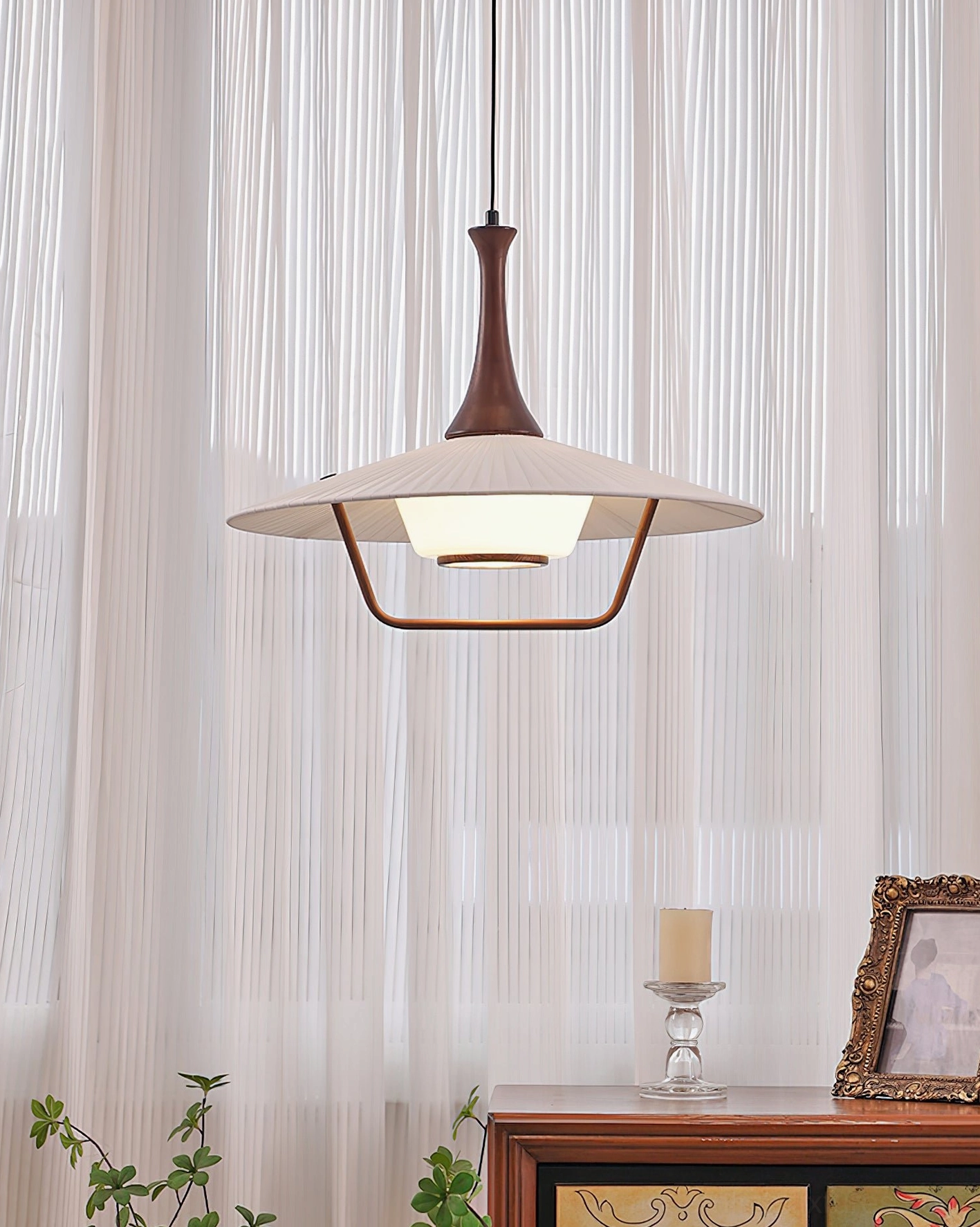 Contemporary pleated pendant ceiling light in cozy living space with soft natural light and sheer curtains