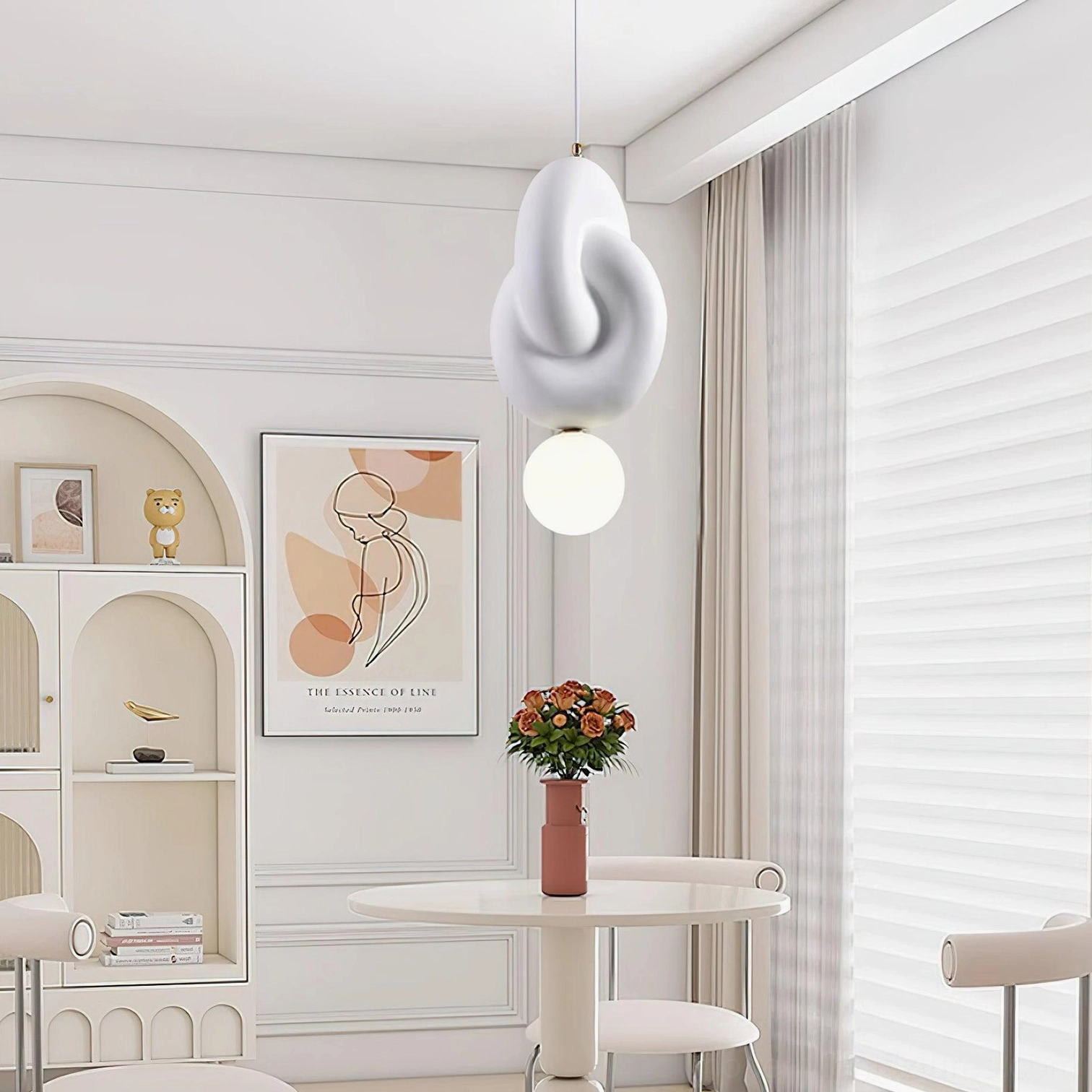 Modern pendant light with twisted knot-shaped upper shade and spherical bulb, contemporary cream style dining nook