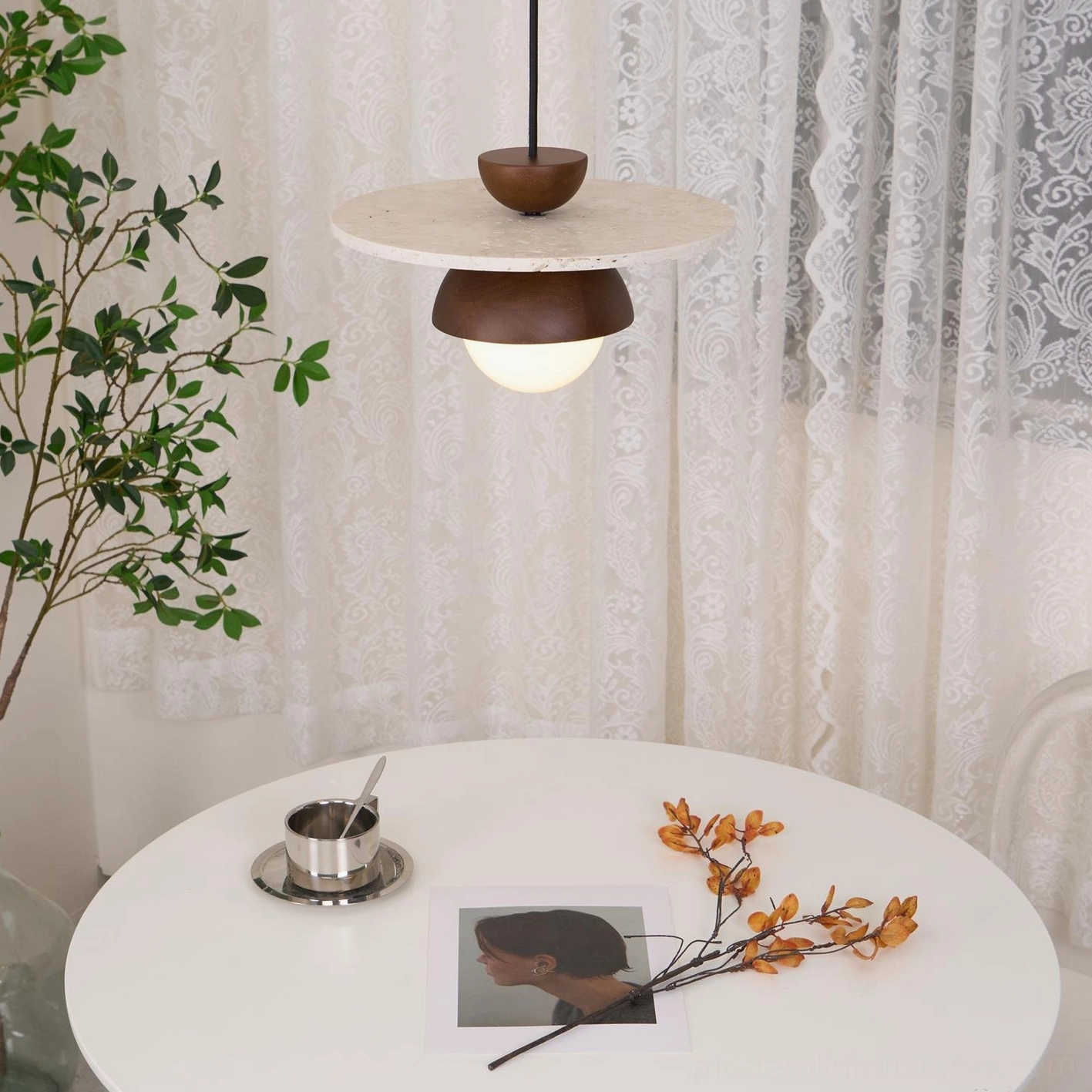 Modern pendant light fixture with natural travertine texture and contemporary metal frame