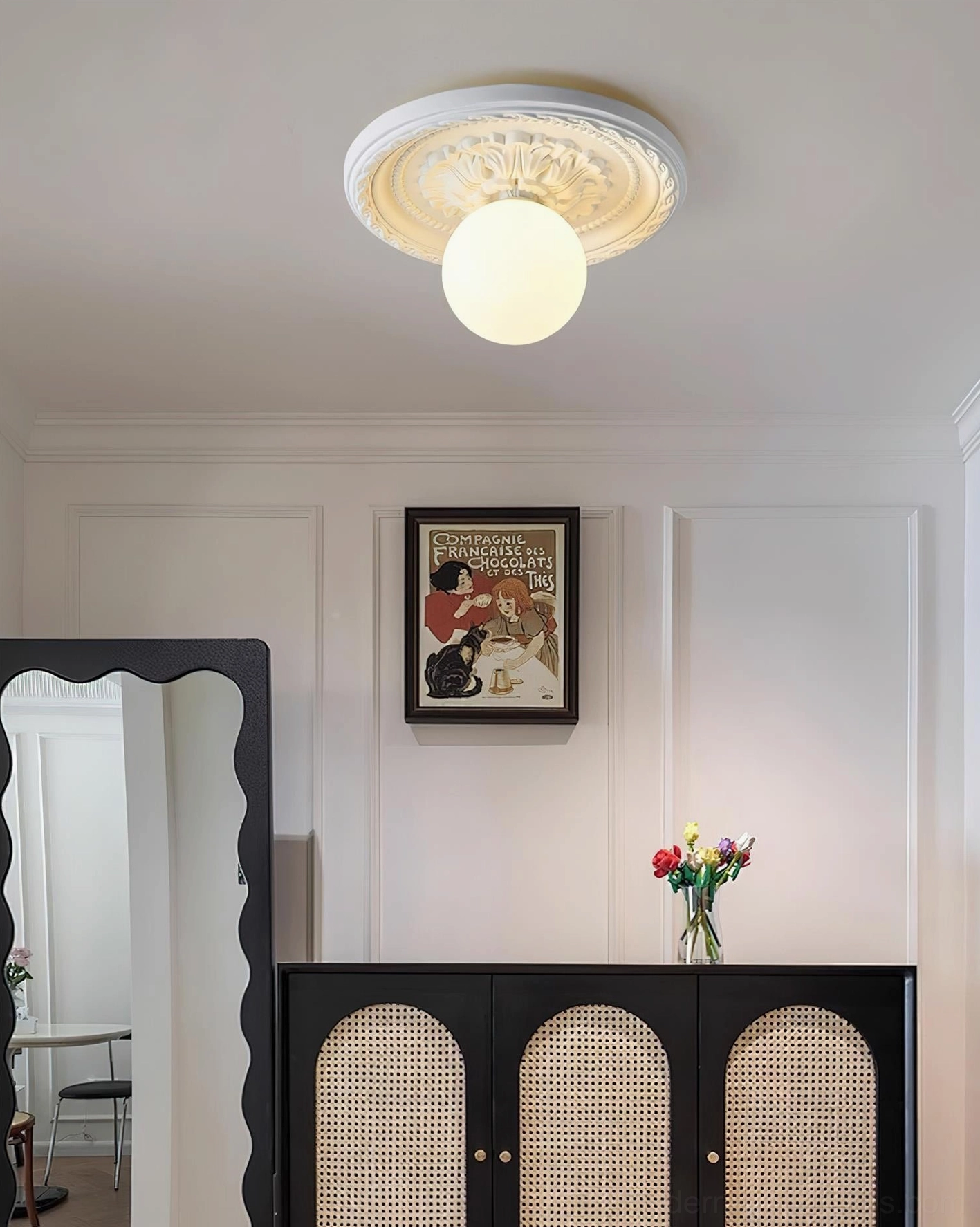 Contemporary resin ceiling light paired with modern rattan cabinet in warm entryway space