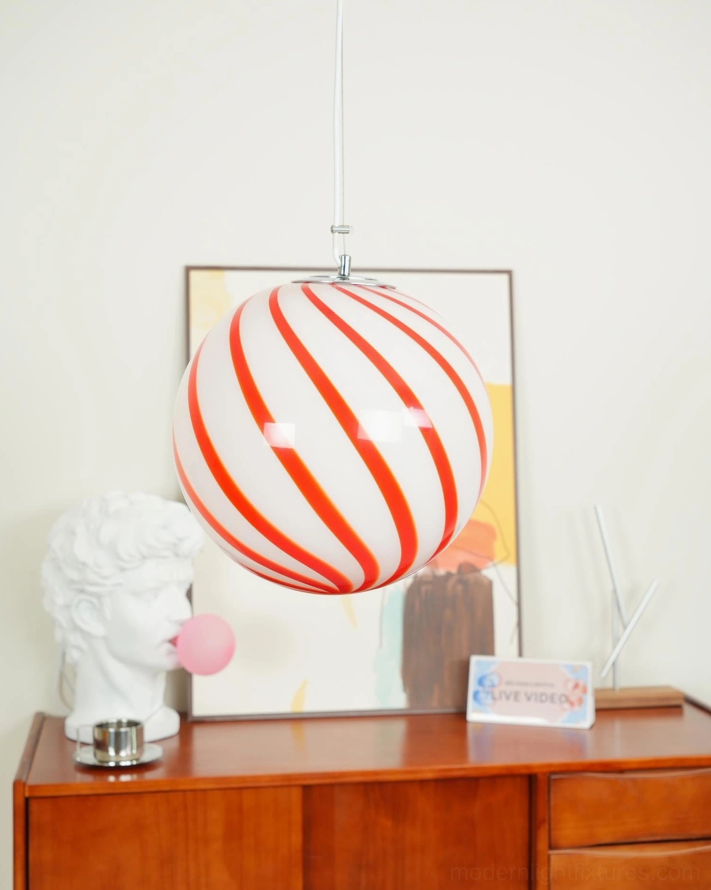 Contemporary spiral stripe pendant light fixture, detailed view of the hand-blown glass globe with fine artisan stripe work