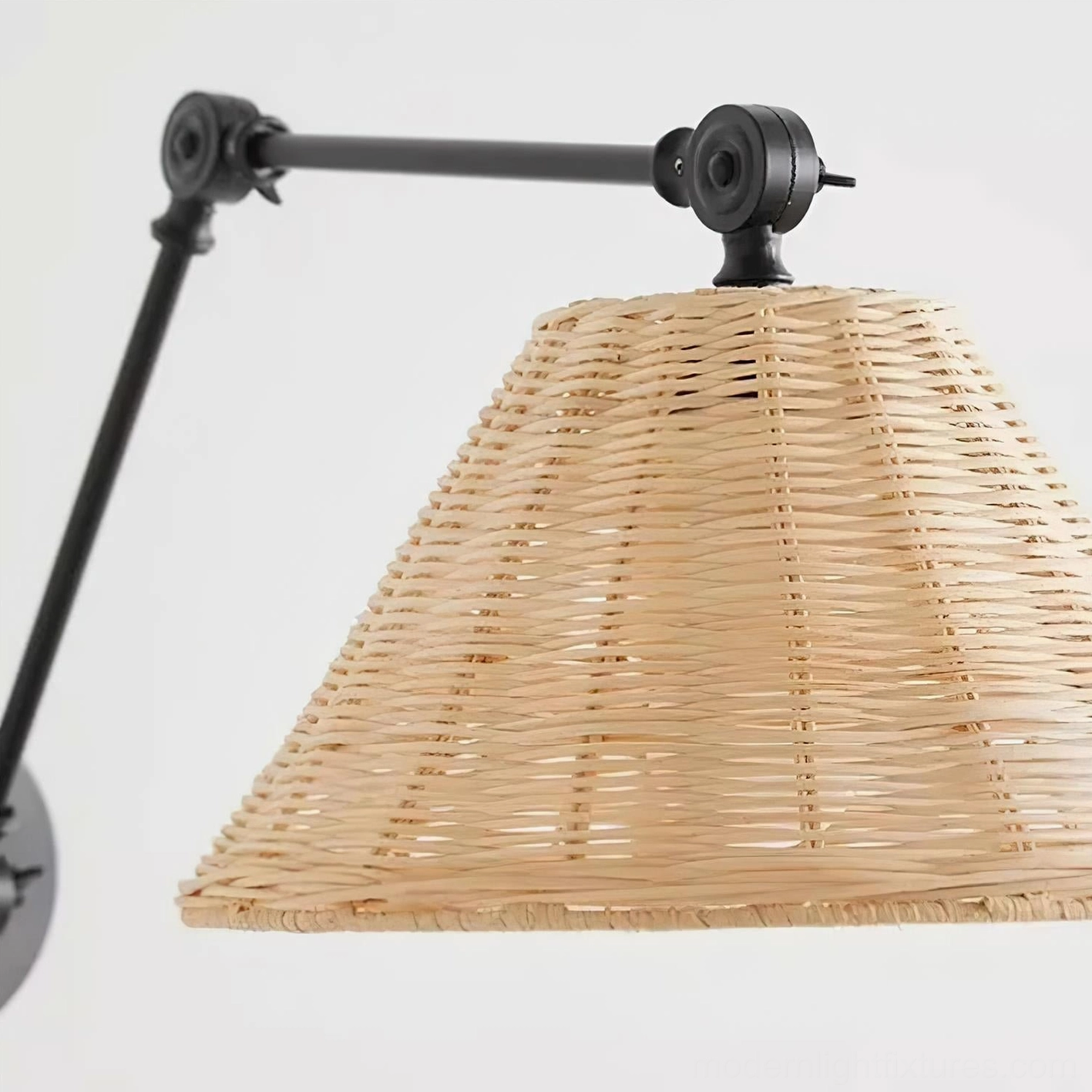 Contemporary swing arm wall sconce with woven rattan shade in mixed interior design style