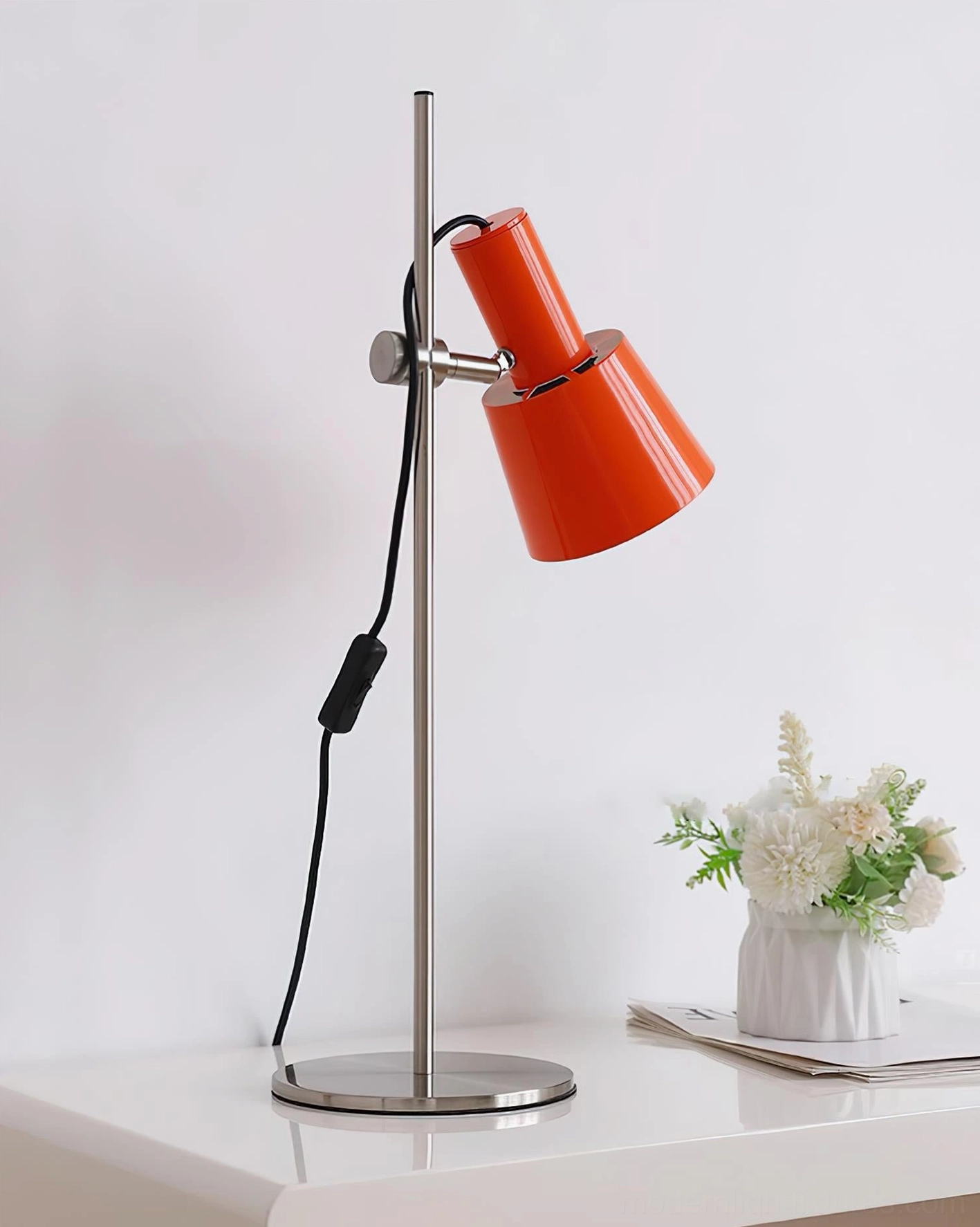 Contemporary adjustable table lamp featuring polished metal construction and directional lighting capability