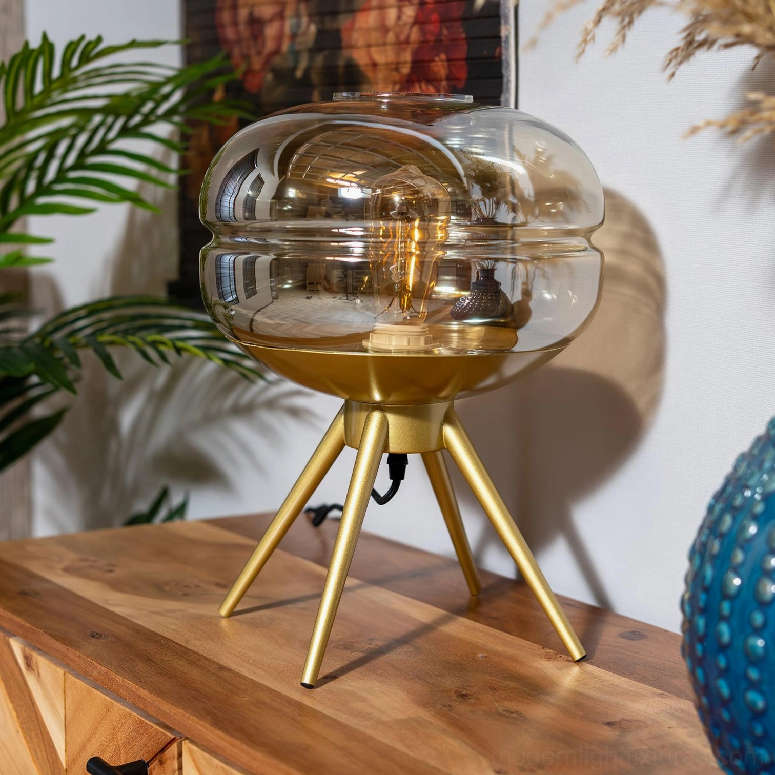 Contemporary tiered glass table lamp with brass base highlighting modern design and light diffusion quality