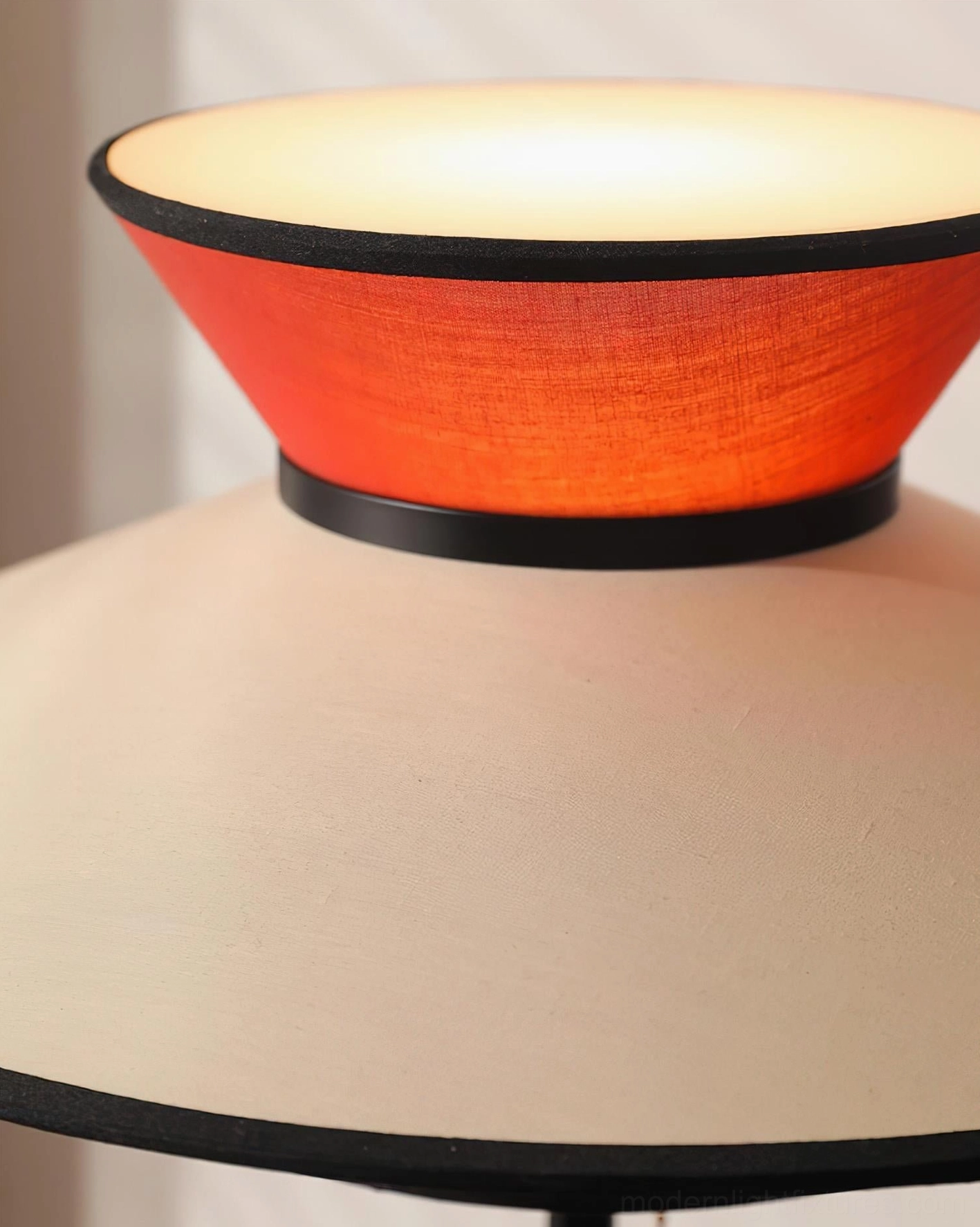 Contemporary table lamp with three-tier geometric layered shade featuring warm ambient lighting for modern home interior design