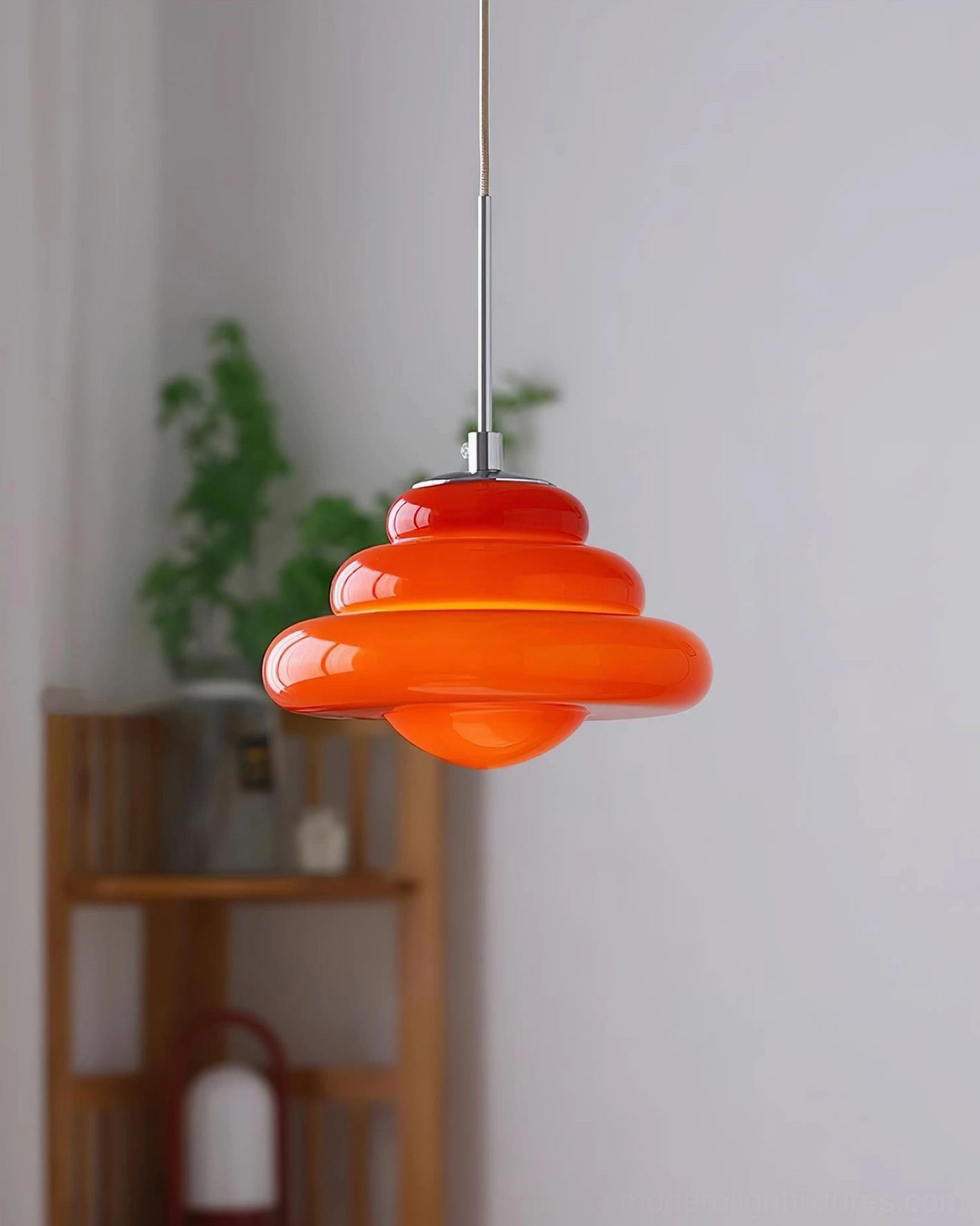 Contemporary tiered glass pendant lamp with glossy finish and minimalist silhouette
