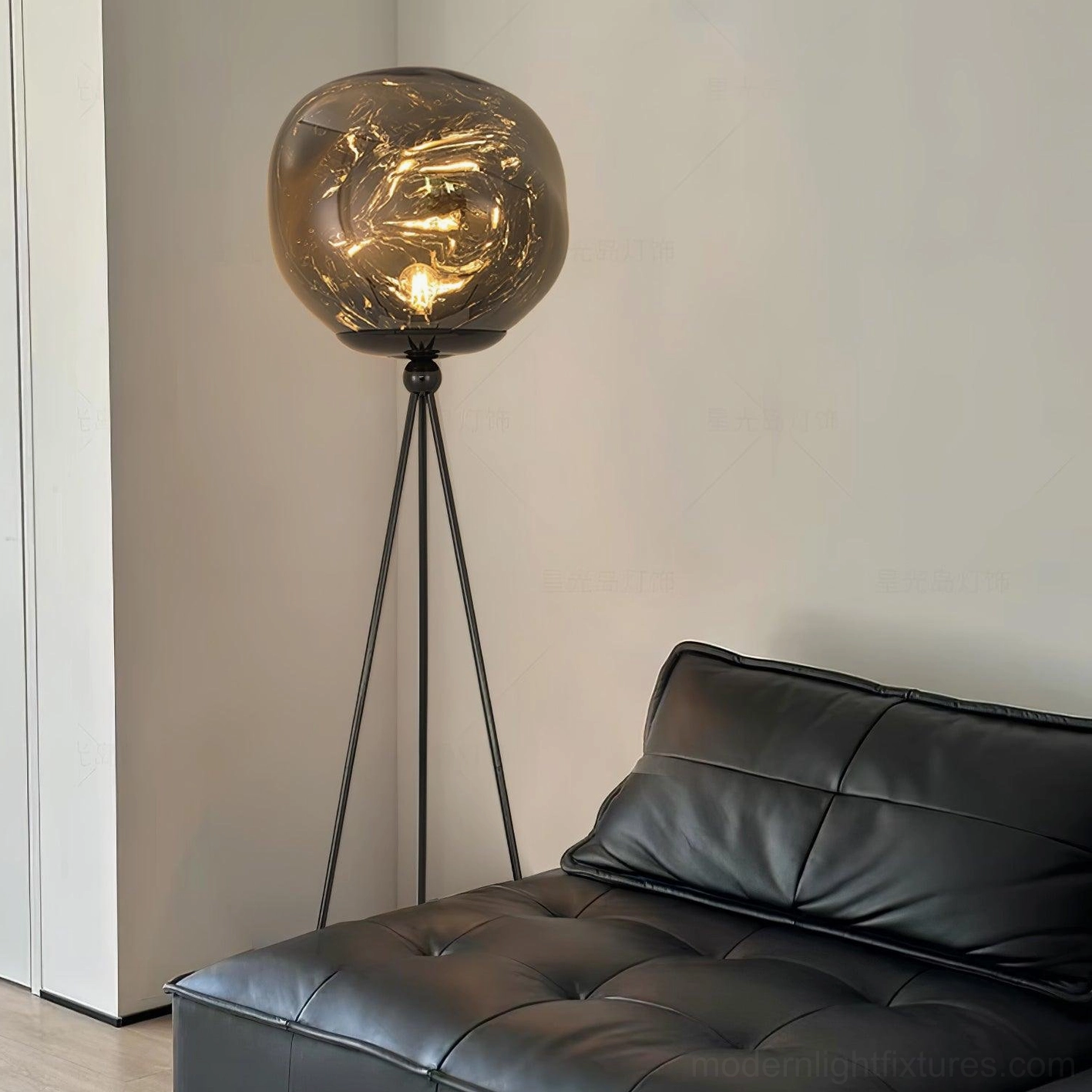 Sleek tripod floor lamp with black metal stand and smoked molten glass shade in contemporary bedroom