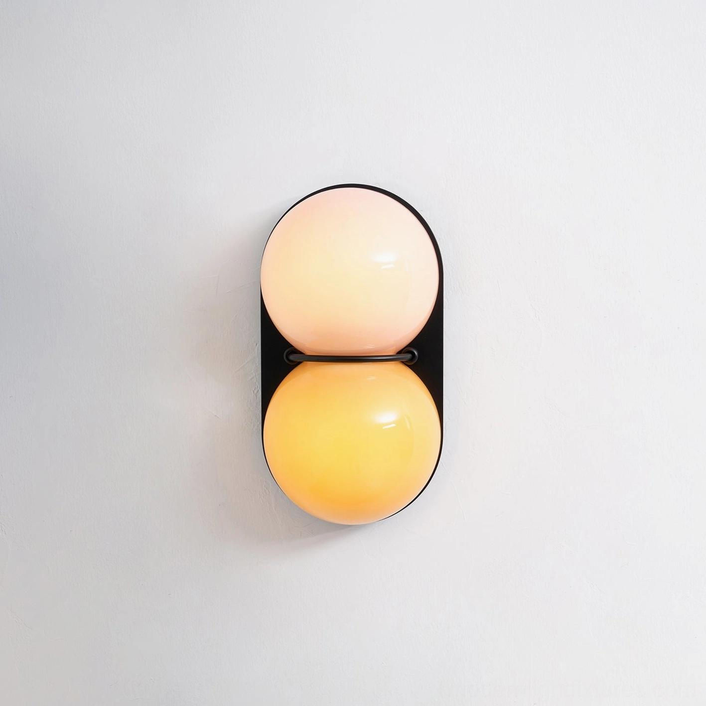 Contemporary Twinwave double glass orb wall sconce mounted in minimalist interior wall