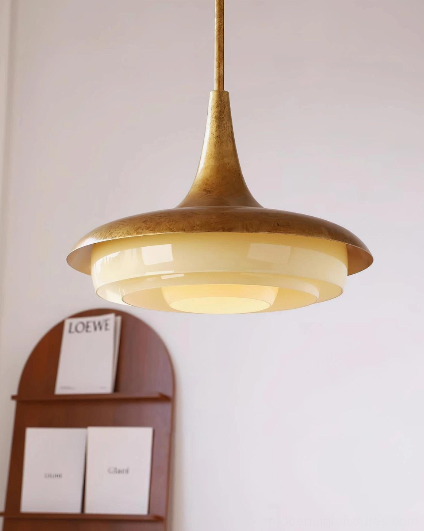 Contemporary vintage brass pendant lamp with cream glass shade, front three-quarter styling shot