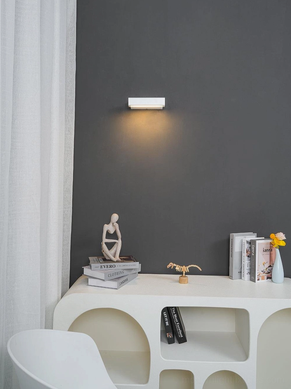 Contemporary minimalist wall sconce in bedroom accent lighting design, paired with modern bedroom furniture