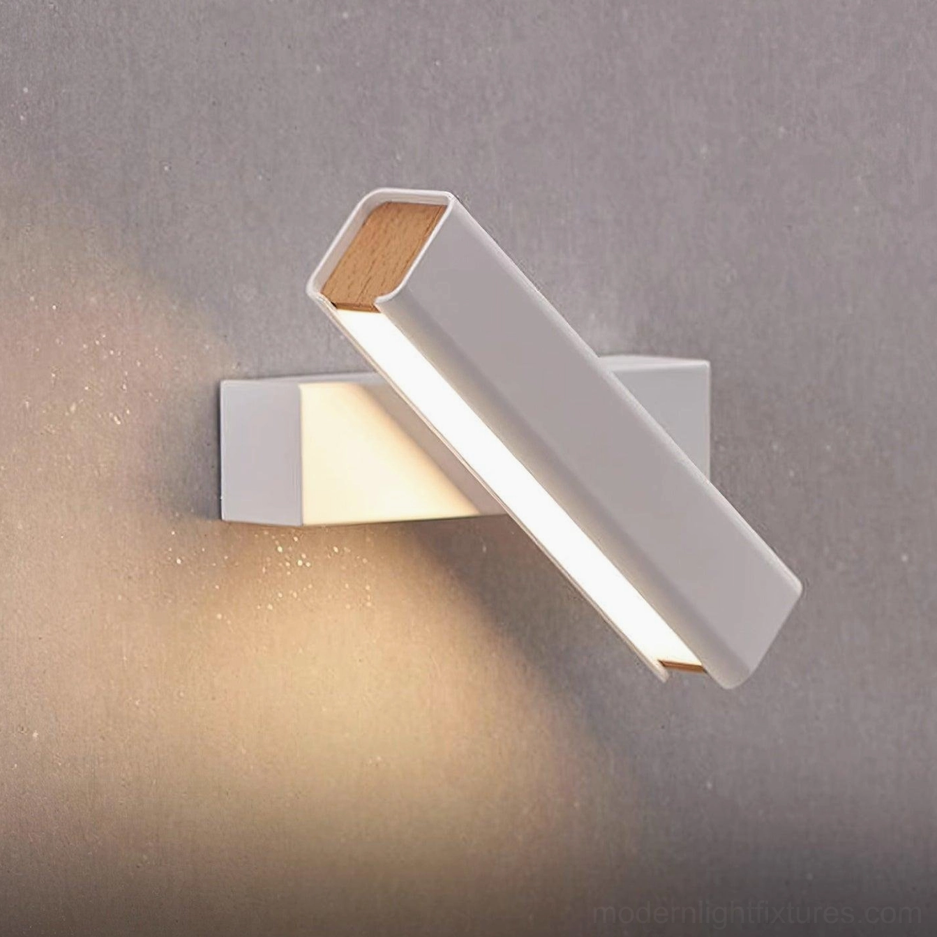 Contemporary rotatable wall sconce in bedroom providing adjustable directional lighting