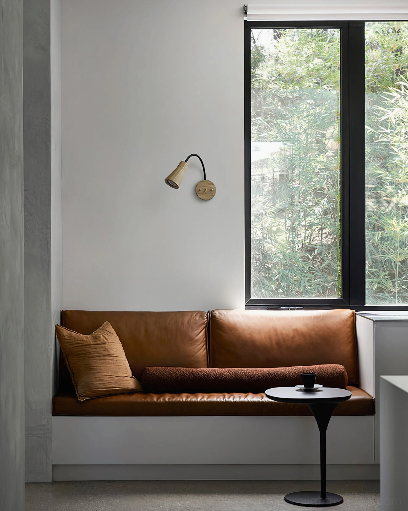 Contemporary wall sconce in living room with warm glowing light, modern interior styling