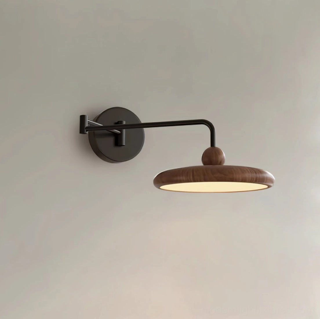 Sleek minimalist wall sconce with wood-grain disc shade and concealed power cord on neutral gray wall