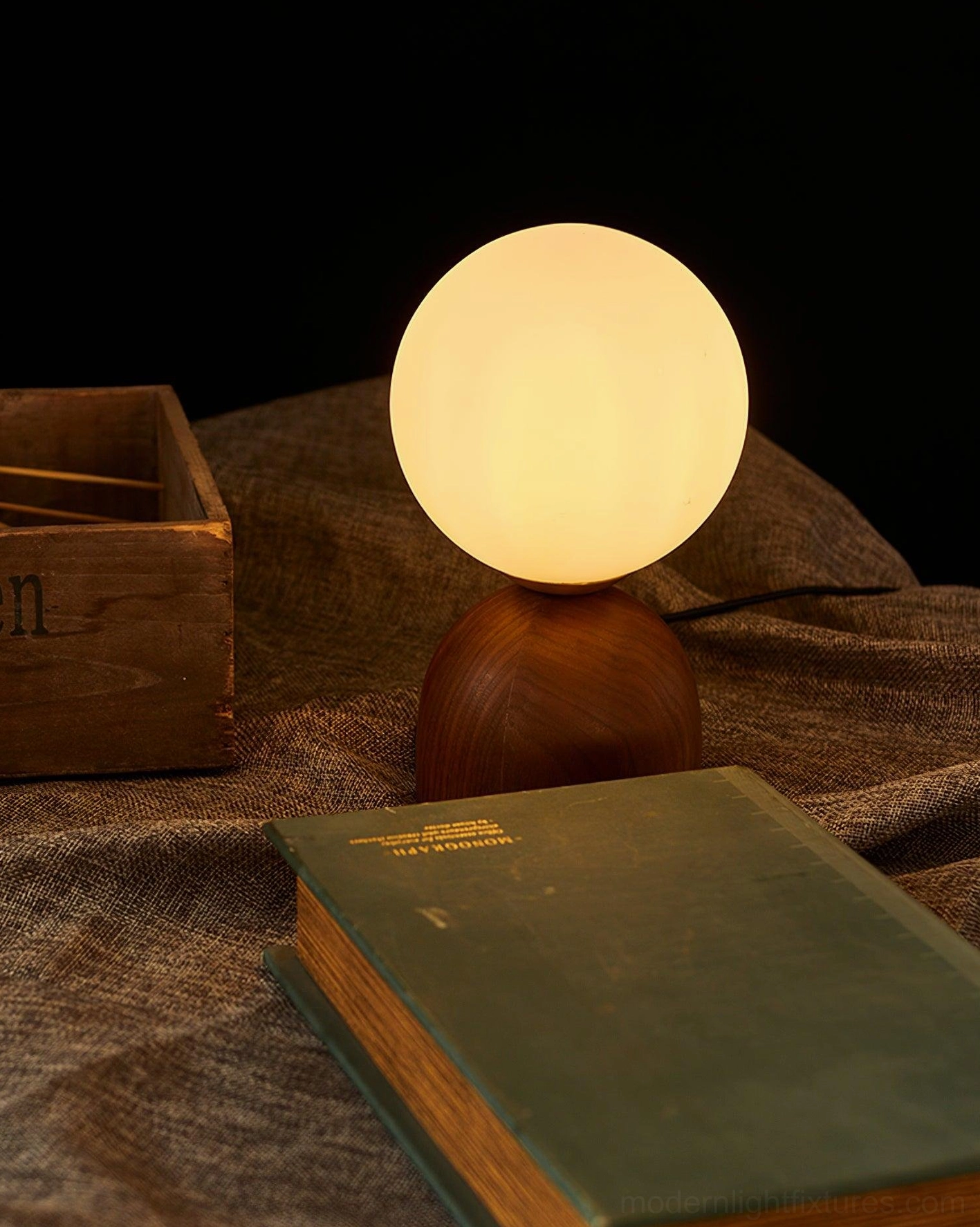 Contemporary walnut wood table lamp with soft frosted glass sphere warm glow atmosphere