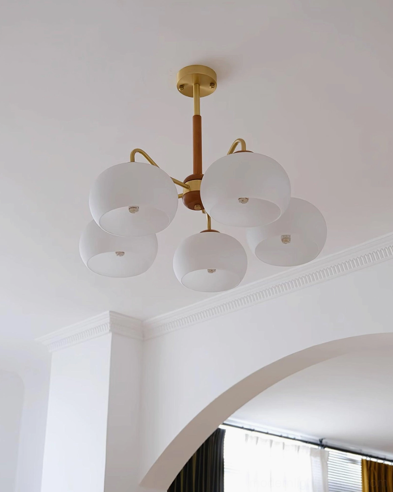 Contemporary wooden brass chandelier fixture with frosted milk glass shades ambient lighting
