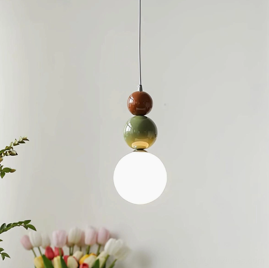 Multiple stacked glass ball pendant lights in coordinated kitchen lighting installation