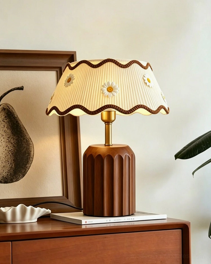 Cordelia cottage table lamp with daisy embroidered pleated shade, brass-tone metal neck and natural walnut fluted base in home setting