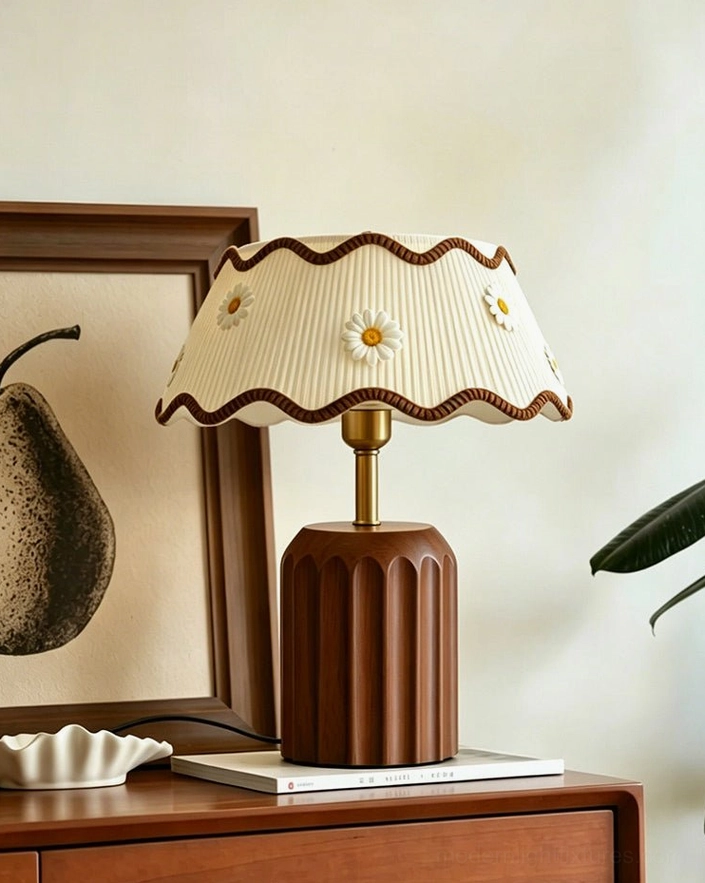 Cordelia cream pleated fabric shade table lamp close-up, daisy appliqué detail and scalloped edge with walnut fluted wooden base