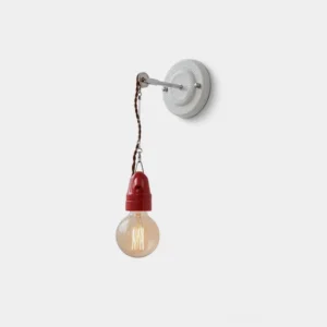 Cordelle exposed bulb ceramic wall sconce with embossed backplate, red twisted fabric cord, and red ceramic E27 holder shown in studio frontal view