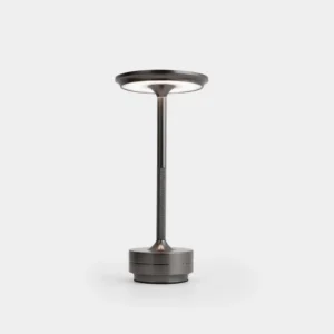 Modern cordless LED table lamp with gunmetal gray aluminum body in minimalist studio setting