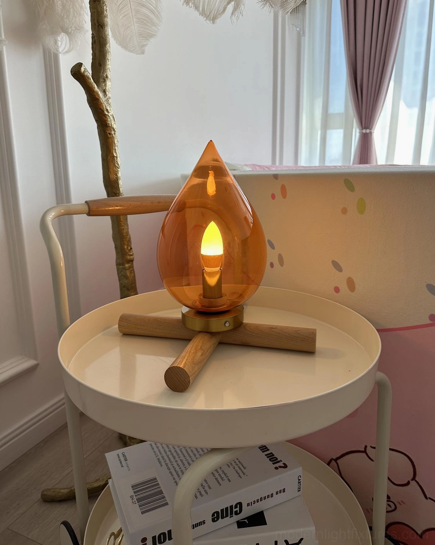 Portable cordless table lamp detail view of amber glass shade and wood base construction