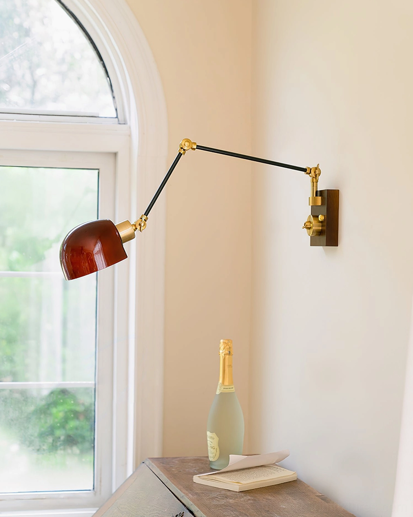 Cordova wall sconce in residential corner near arched window with dark burgundy dome