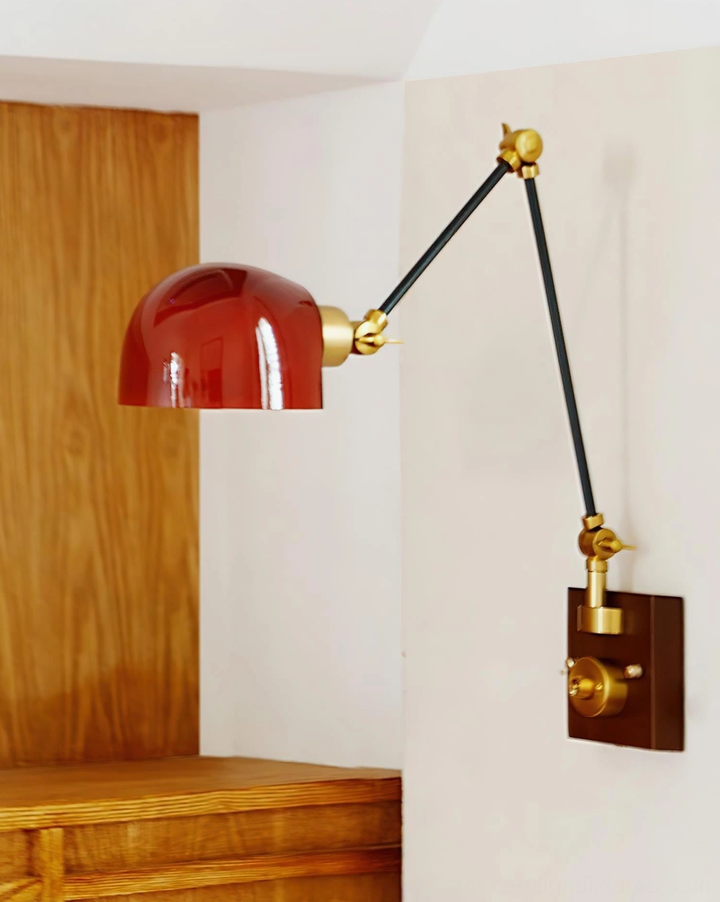 Cordova vintage-inspired wall lamp with burgundy dome on wood paneling, articulating arm extended