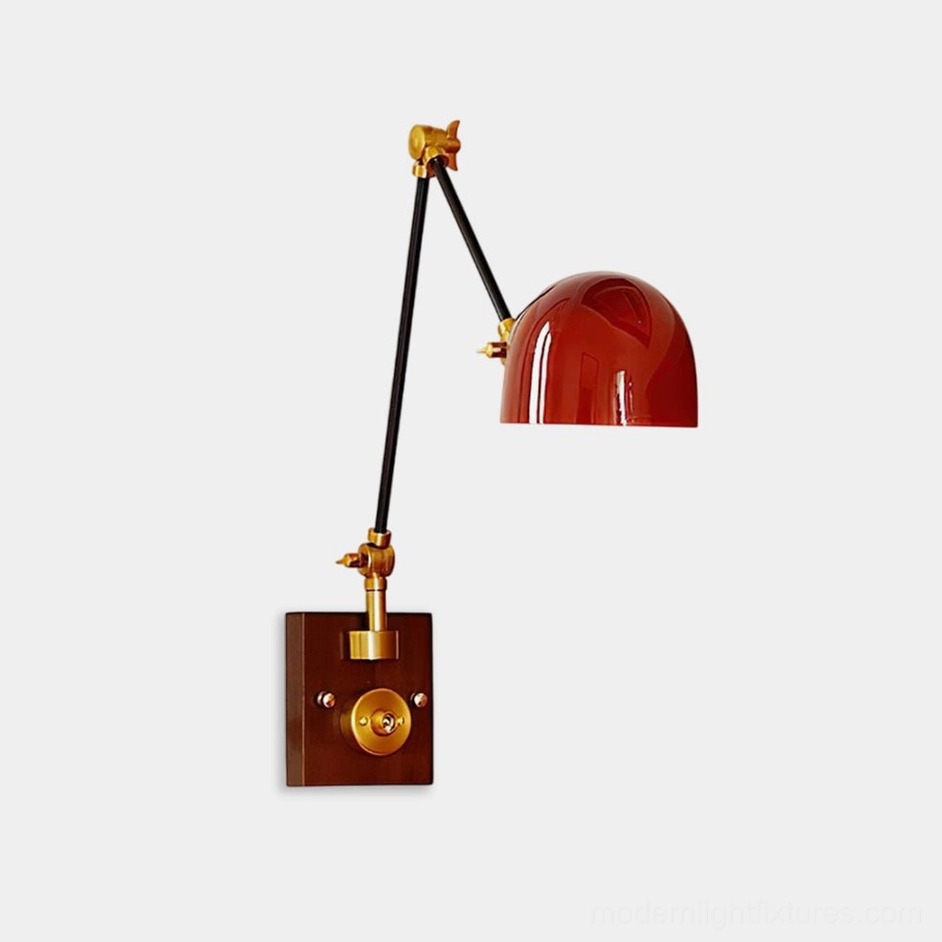 Cordova adjustable wall sconce with red dome shade and articulating arms, front three-quarter studio view