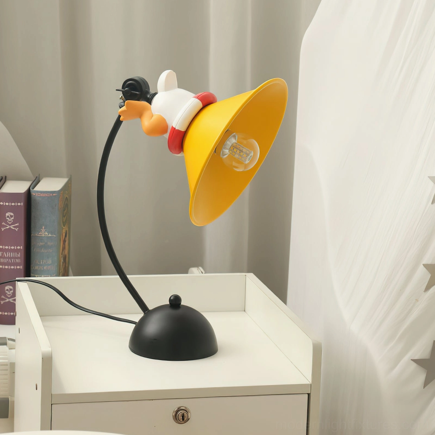 Corgi table lamp positioned on white bedside nightstand with stacked books and sheer curtains, creating cozy bedroom ambiance with modern decorative lighting