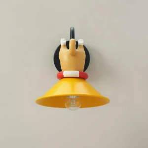 Cute cartoon corgi wall lamp front view displaying exposed LED bulb inside yellow shade on light gray wall background