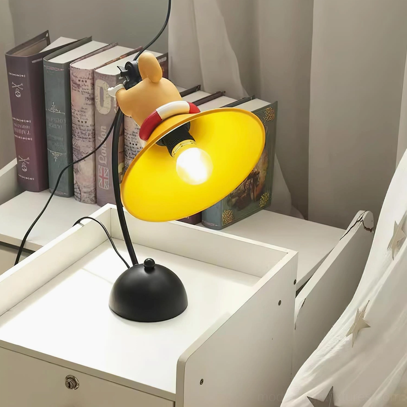 Fully lit corgi cartoon table lamp on nightstand with adjacent stack of books and sheer curtain backdrop, showing functional modern bedroom lighting