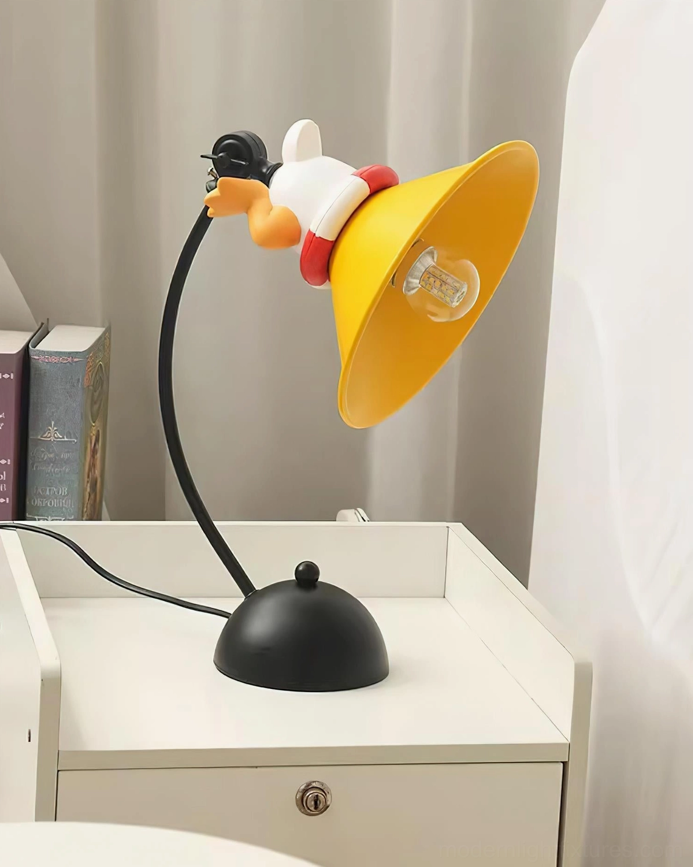 Right front angle view of glowing corgi table lamp with books stacked beside nightstand, demonstrating playful modern desk lighting design