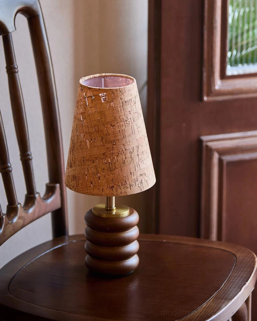 Traditional walnut wood table lamp with cork shade on round side table beside vintage dining chair