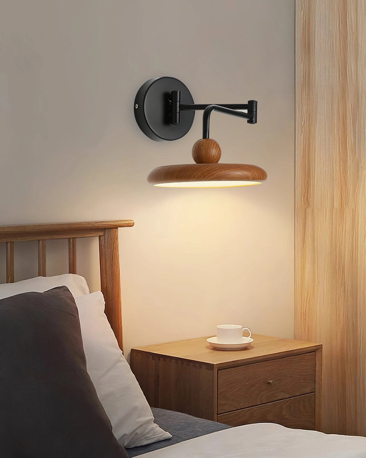 Modern wall sconce providing layered lighting solution for bedroom corner with versatile directional arm design