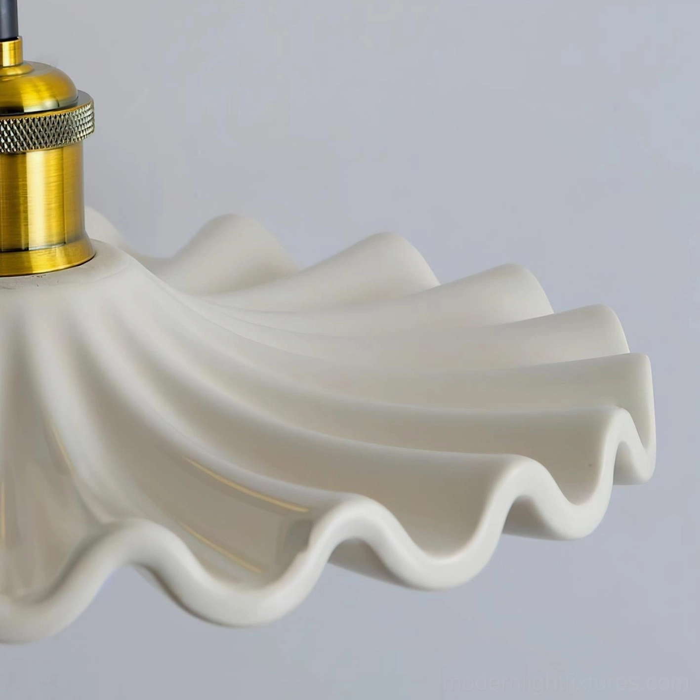 Corolla pendant light side close-up view of ruffled scalloped ceramic edge and brass fitting detail