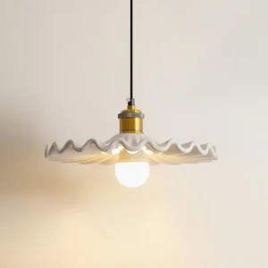 Corolla pendant lamp with brass hardware and white ceramic scalloped shade, three-quarter angle