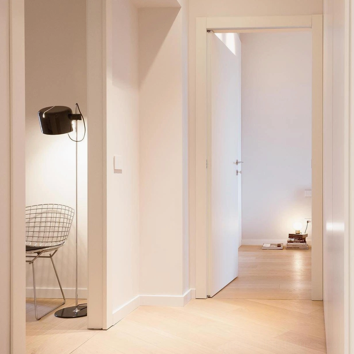 Coupé articulated floor lamp providing ambient and task lighting in dual-purpose interior space