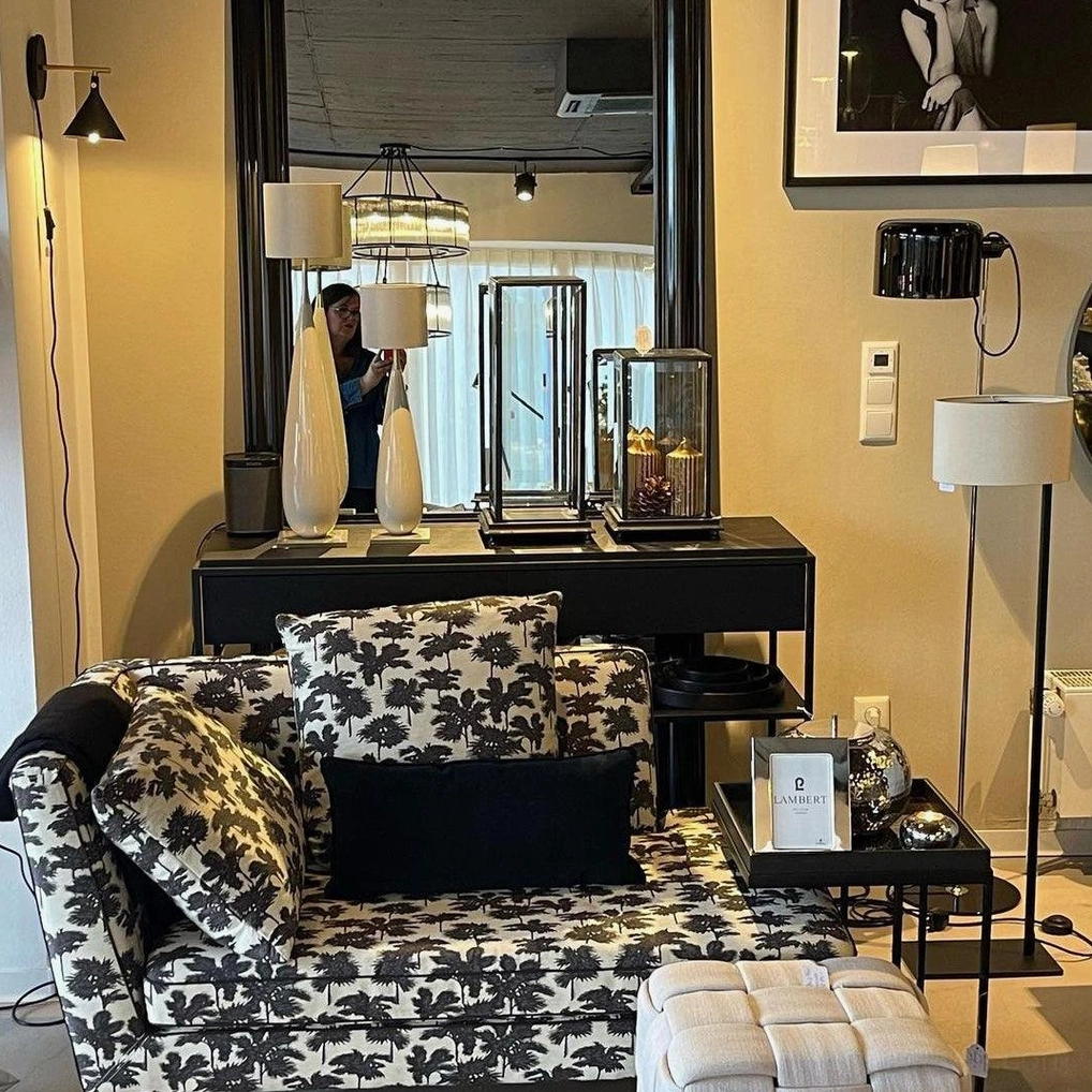 Multiple decorative floor lamps with mixed black and white shades in luxury home vanity display area