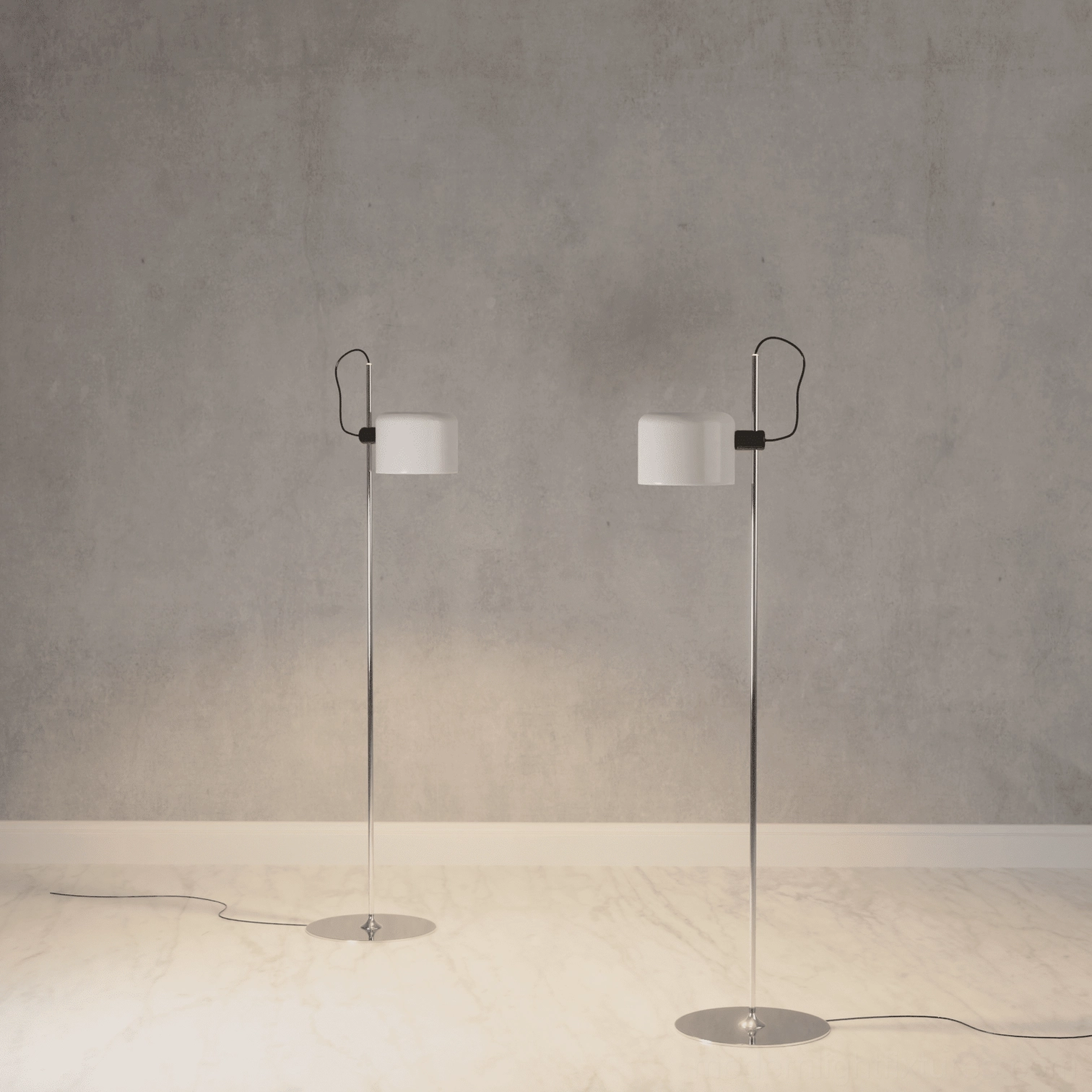 Pair of matching Coupé floor lamps with white drum shades and silver metal construction on concrete wall backdrop