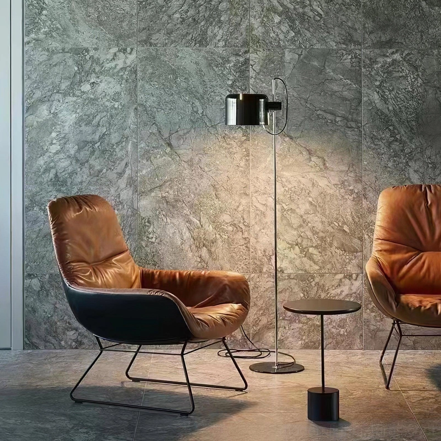 Coupé articulated floor lamp in contemporary living room with leather armchair and polished metal pole