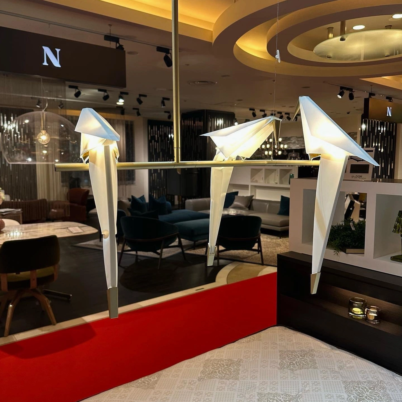 Paper crane chandelier installation suspended from ceiling interior design