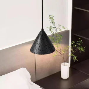 Modern conical travertine pendant lamp hanging in contemporary bedroom, side profile view with warm ambient glow