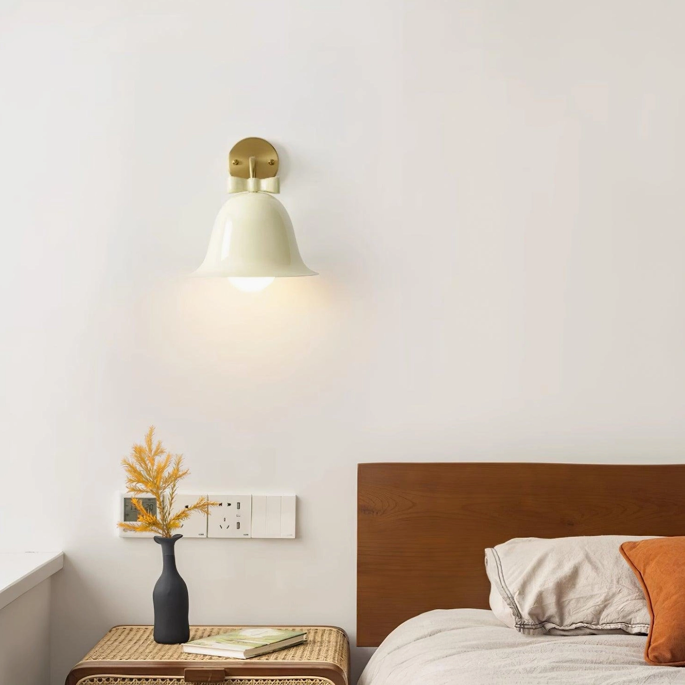Cozy bedroom bedside ceramic bell wall sconce with cream shade and brass base providing warm light
