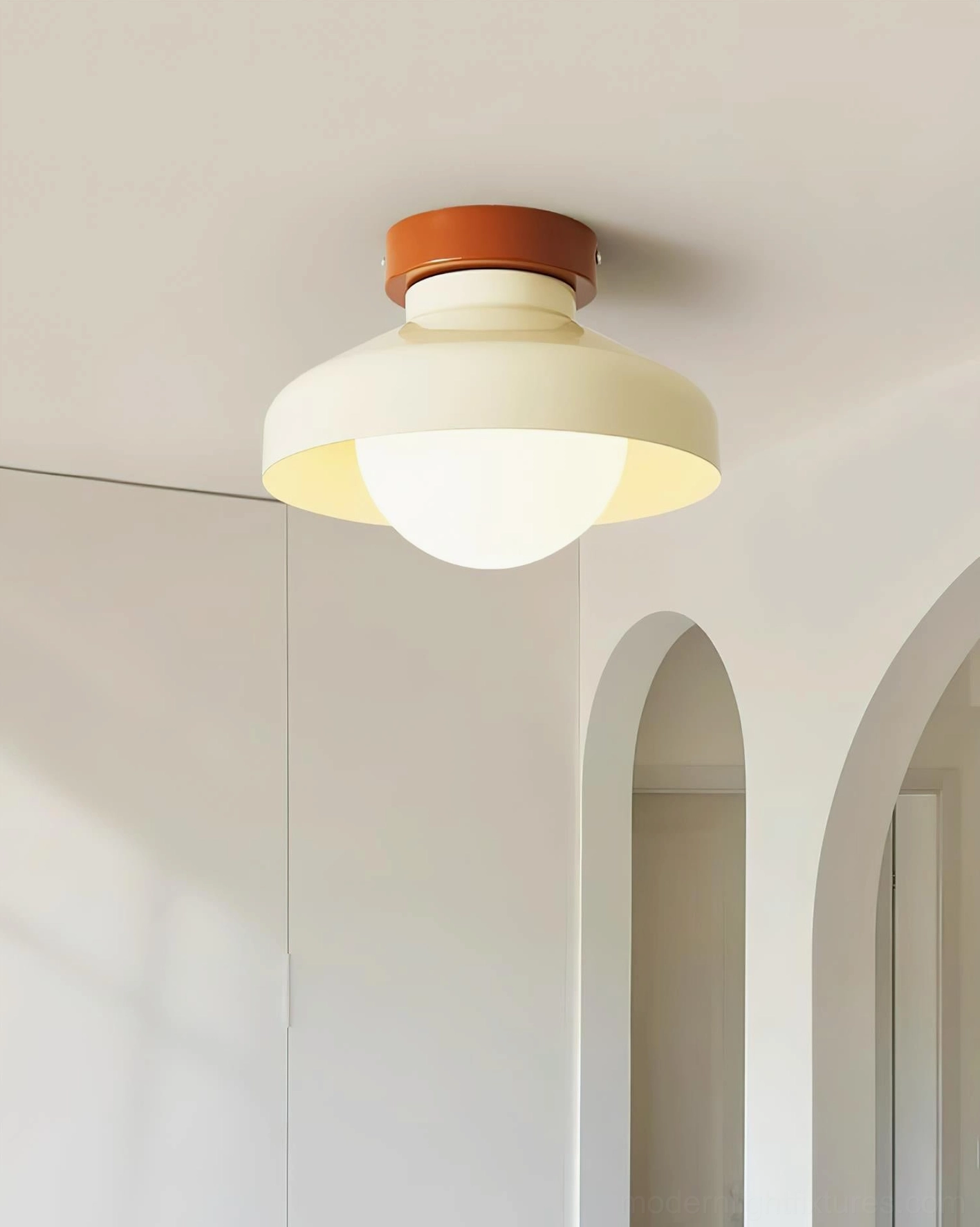 Cream white Calico modern ceiling light fixture in hallway with arched doorframes, soft neutral ambient lighting