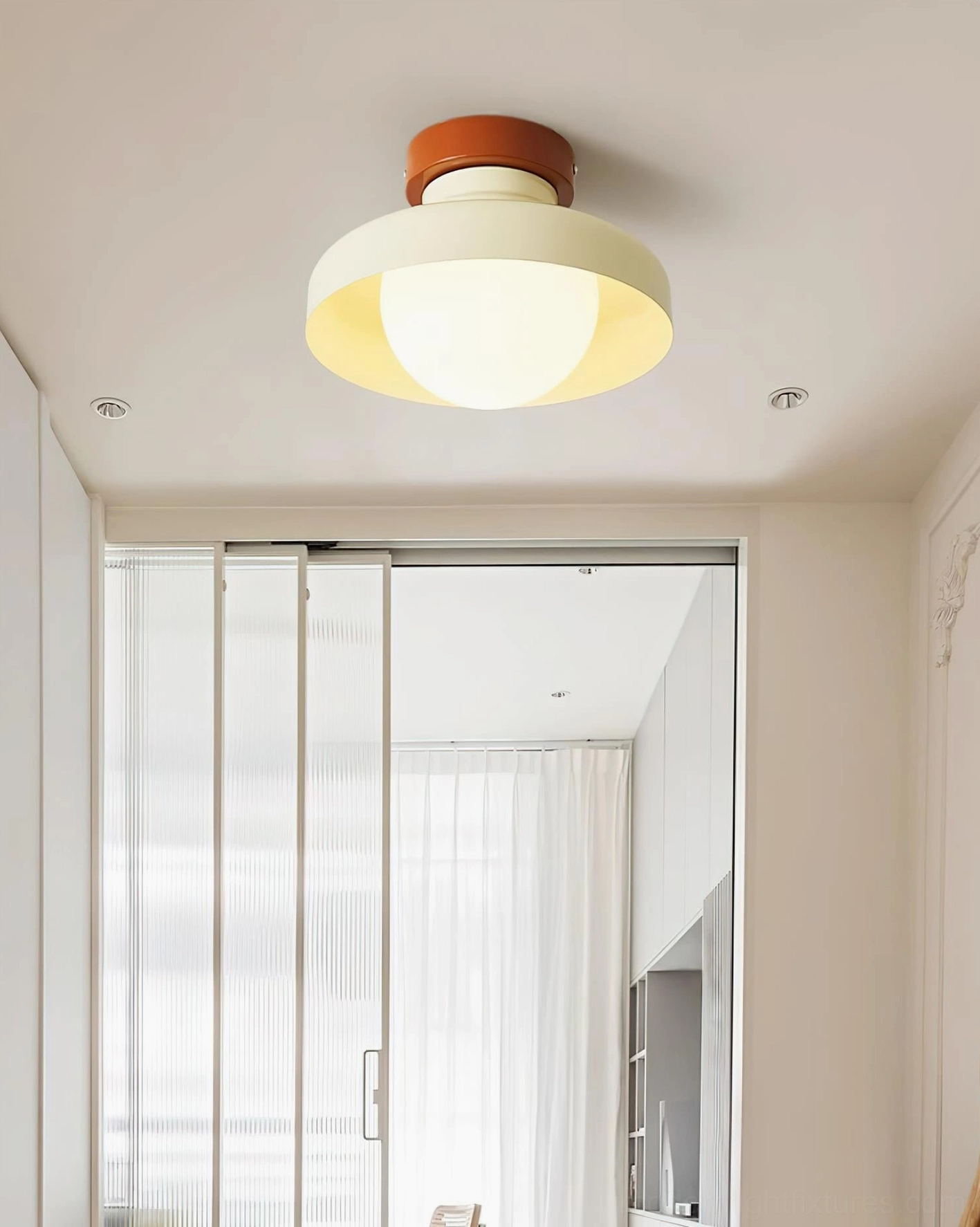 Cream white Calico modern ceiling light fixture in contemporary kitchen with central island and wooden cabinetry