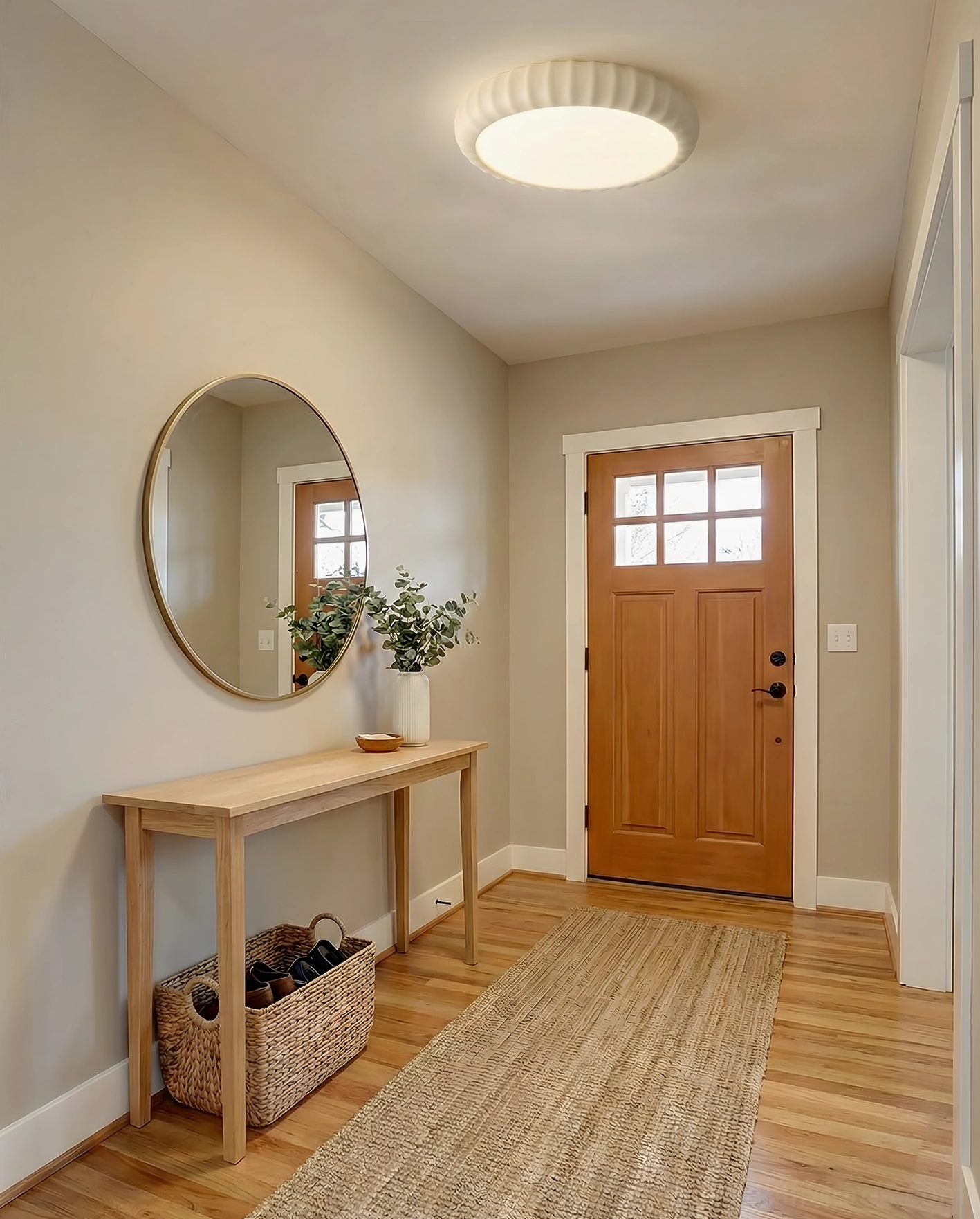 Cream colored fluted ceiling light in home entryway hallway - wooden mirror background
