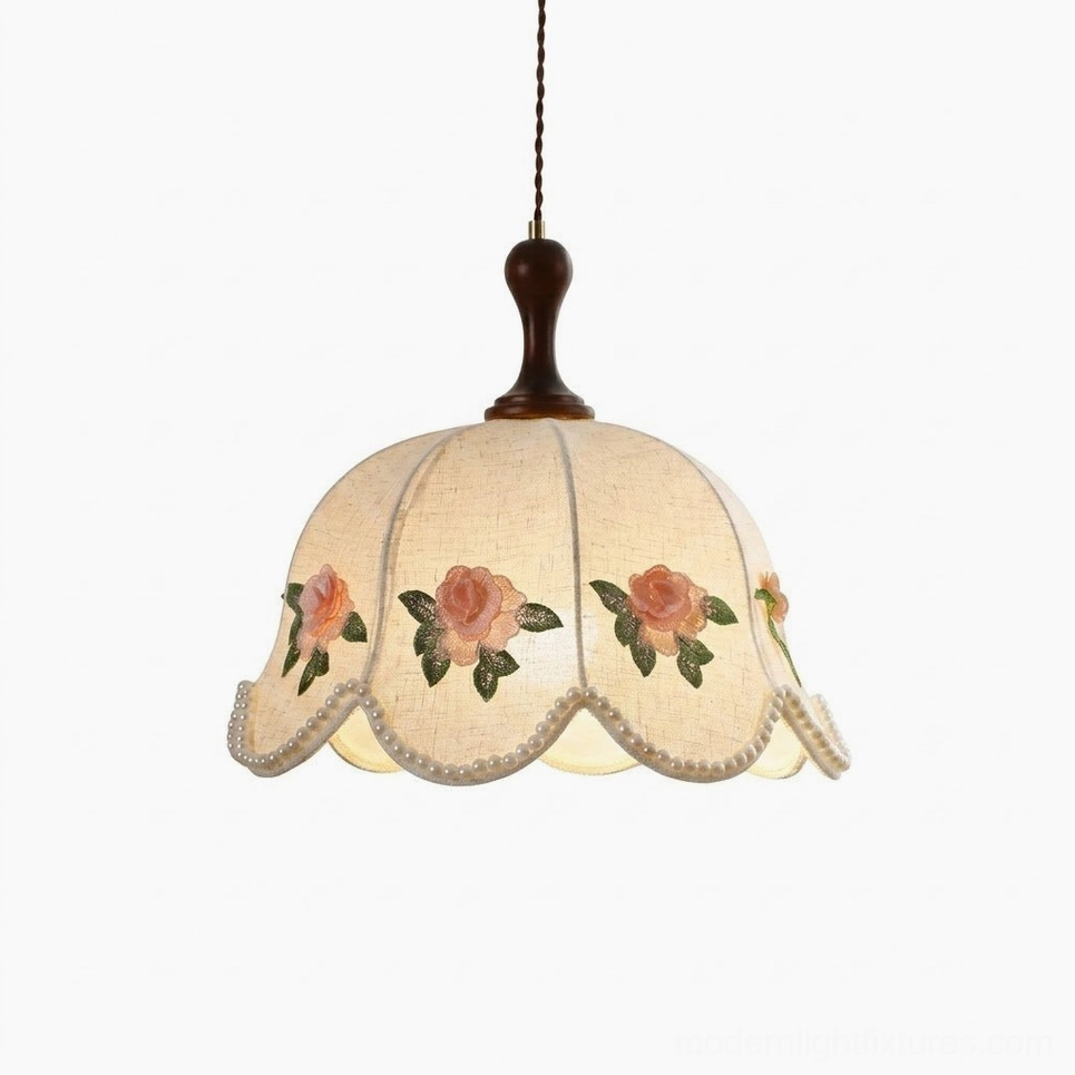 Cream embroidered rose pendant light with scalloped linen shade and walnut wood stem, studio front view