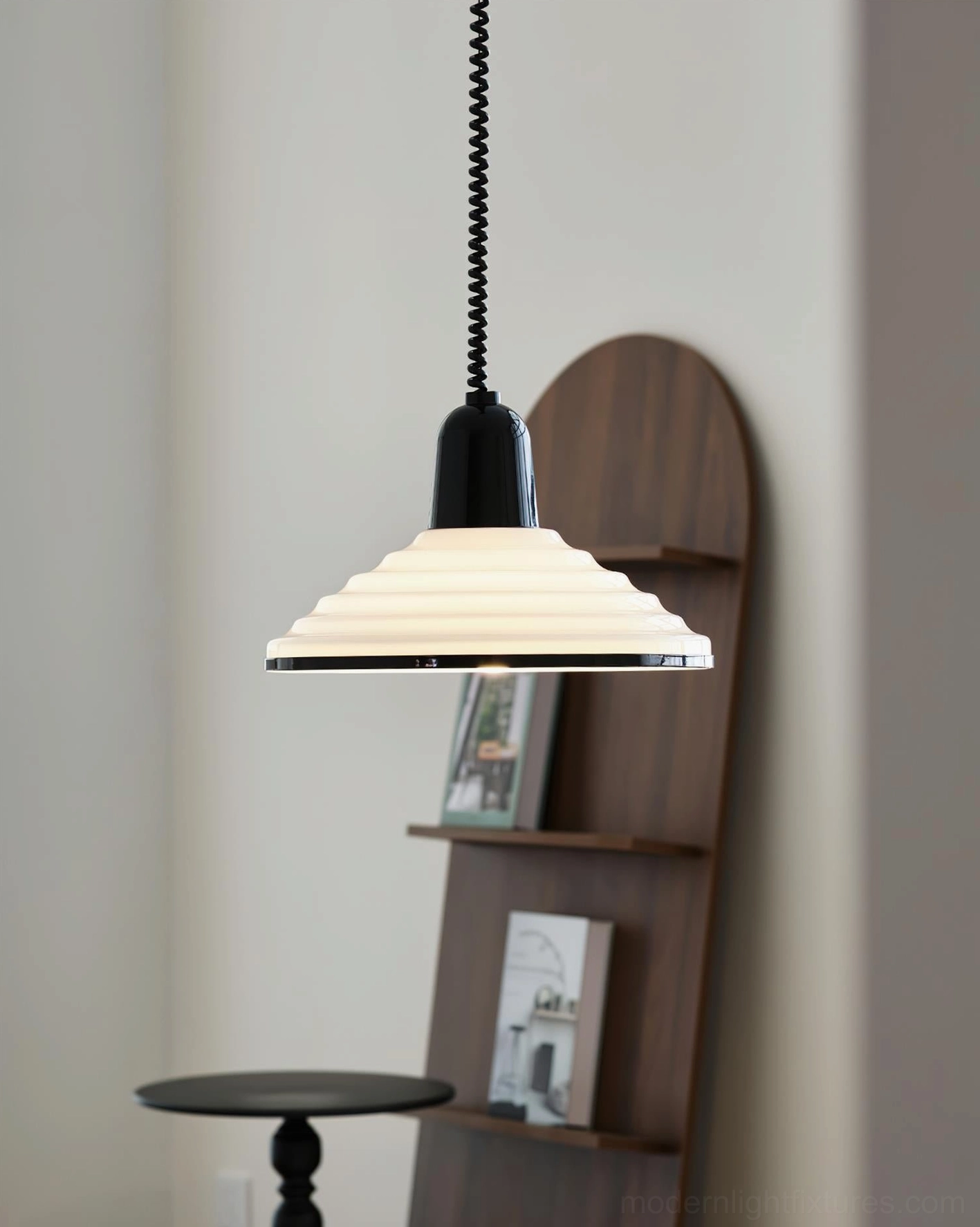 Cream ribbed metal pendant lamp in side view hanging in cozy residential corner with small table and wooden wall shelving