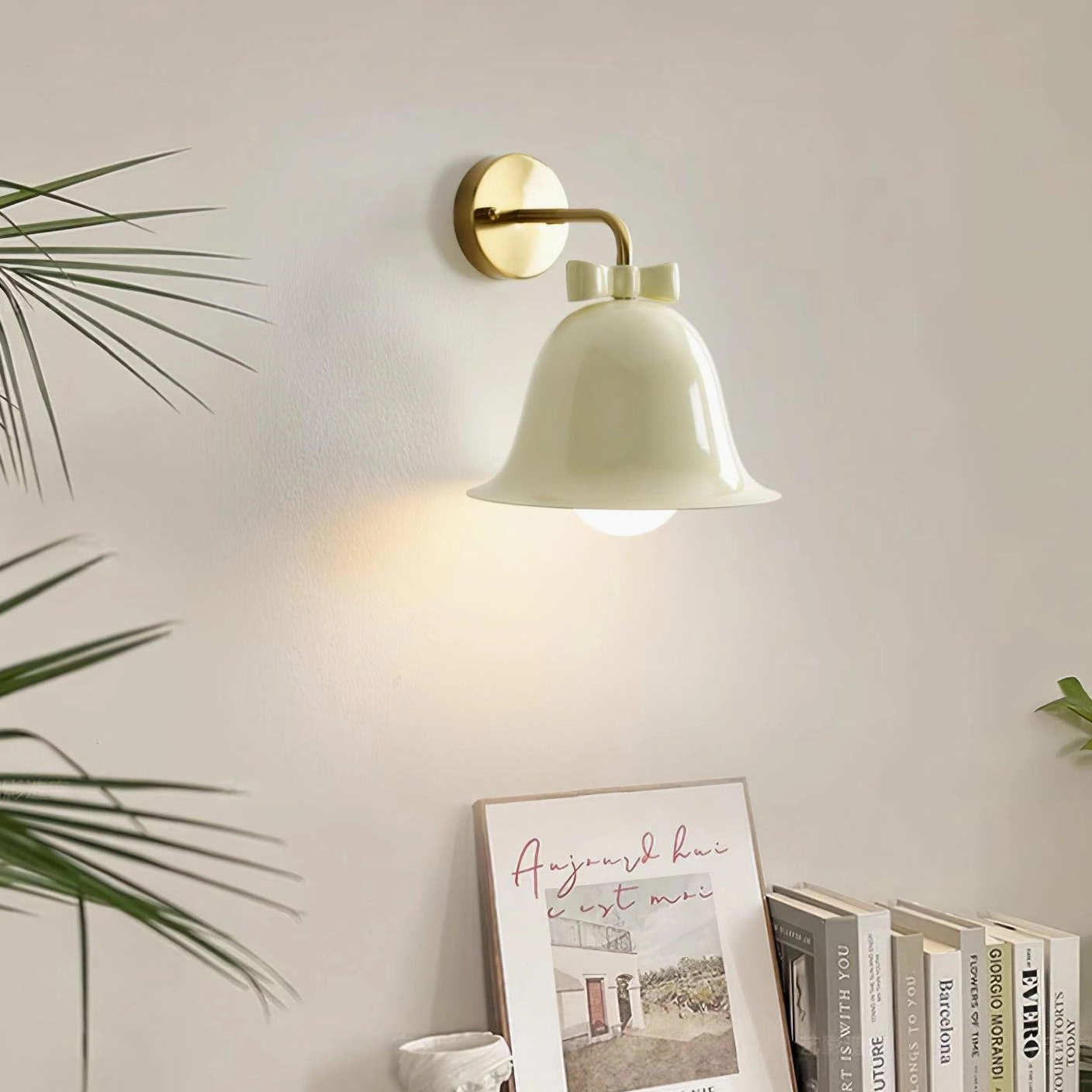 Cream white ceramic bell wall sconce installed in cozy living room corner with warm ambient lighting