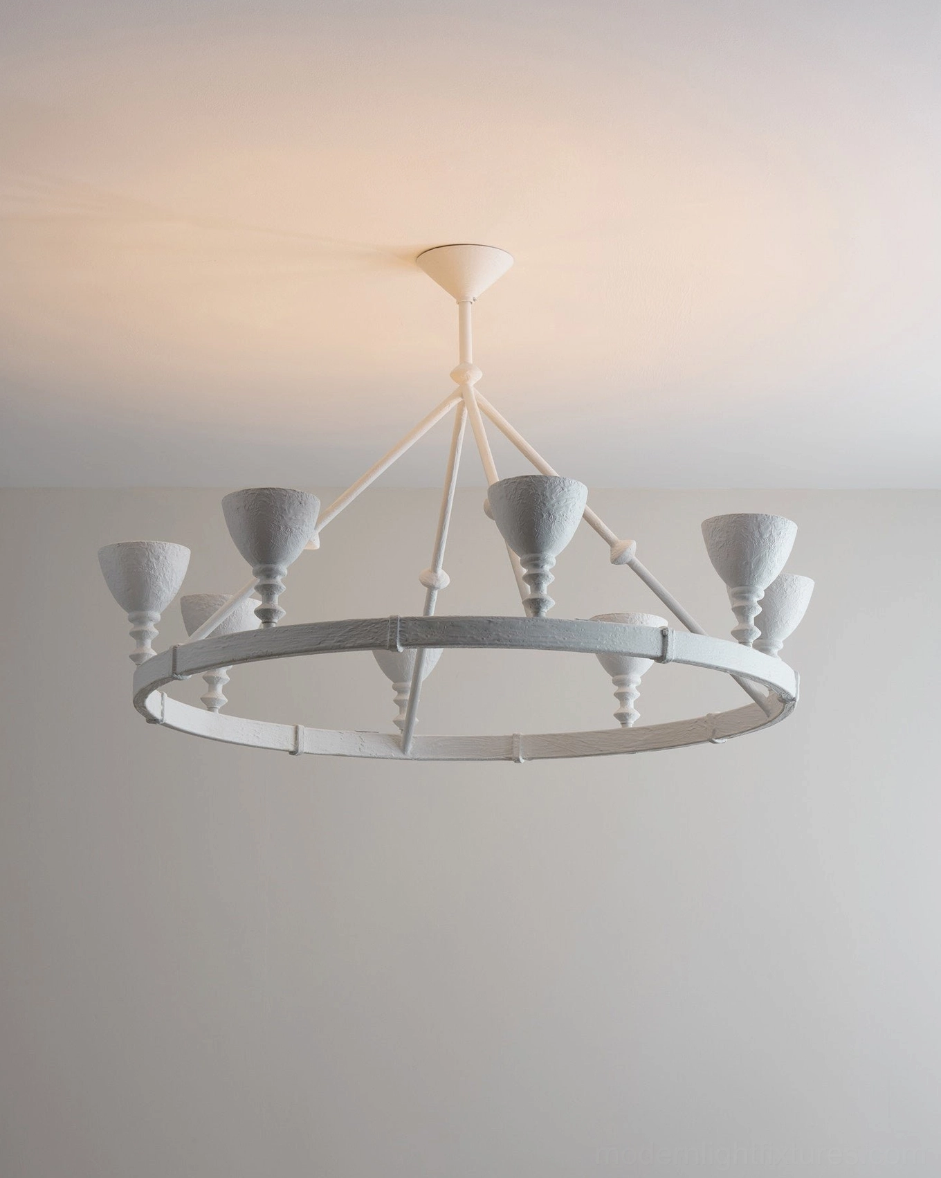 Cremora chandelier detail shot overhead angle showing matte white weathered finish and six candlestick-style lamp holders